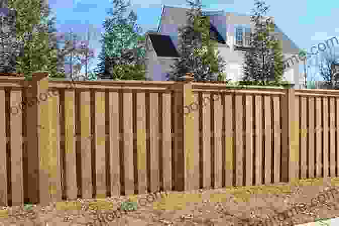 A Wooden Fence With Decorative Cutouts, Providing Privacy And Adding A Touch Of Rustic Charm To The Backyard House And Home: Creating A Beautiful Home: 10 Hardscape Ideas For A Beautiful Yard