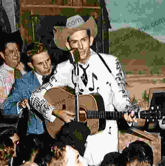 Hank Williams Holding A Guitar, Wearing A Cowboy Hat And A Suit, Performing On Stage Hank Williams: The Biography Colin Escott